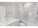 Bright bathroom featuring a shower-tub combo, large mirror, and modern sink at 129 Mossy Falls Way, Wendell, NC 27591