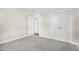 Neutral bedroom featuring carpeted floor, white trim and doors, and closet for ample storage at 129 Mossy Falls Way, Wendell, NC 27591
