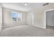 A bedroom with gray carpet and a large window at 129 Mossy Falls Way, Wendell, NC 27591