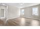 Bright bedroom with hardwood floors and ample natural light from two large windows at 129 Mossy Falls Way, Wendell, NC 27591
