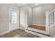 Bright entryway with wood floors, white trim, and access to the staircase and backyard at 129 Mossy Falls Way, Wendell, NC 27591