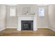 Close-up of a modern fireplace with a white mantle, flanked by windows in the living room at 129 Mossy Falls Way, Wendell, NC 27591
