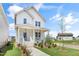 A charming two-story house featuring a quaint porch and inviting curb appeal at 129 Mossy Falls Way, Wendell, NC 27591