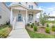 A close-up view of the entry showcasing the light blue front door and cozy porch area at 129 Mossy Falls Way, Wendell, NC 27591