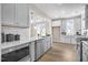 Stylish kitchen with stainless appliances, white cabinets and an adjacent dining area at 129 Mossy Falls Way, Wendell, NC 27591
