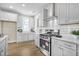 Bright kitchen with white cabinets, stainless steel appliances, and a subway tile backsplash at 129 Mossy Falls Way, Wendell, NC 27591
