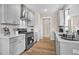 Modern kitchen featuring white cabinets, stainless steel appliances, and hardwood floors at 129 Mossy Falls Way, Wendell, NC 27591