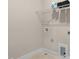 A white laundry room with wire shelving above the washing machine hook ups at 129 Mossy Falls Way, Wendell, NC 27591