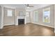 Spacious living room with hardwood floors, a fireplace, and ample natural light at 129 Mossy Falls Way, Wendell, NC 27591