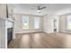 Bright living room featuring a fireplace, hardwood floors, and views to the exterior at 129 Mossy Falls Way, Wendell, NC 27591