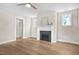 Inviting living room with a fireplace, hardwood floors, and a ceiling fan at 129 Mossy Falls Way, Wendell, NC 27591