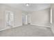 The carpeted main bedroom is adjacent to the bathroom with dual closets at 129 Mossy Falls Way, Wendell, NC 27591