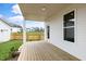 Covered porch with wood flooring, overlooking the fenced backyard and neighborhood at 129 Mossy Falls Way, Wendell, NC 27591