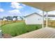 Backyard porch showcasing wooden decking and a fenced-in yard, perfect for relaxing at 129 Mossy Falls Way, Wendell, NC 27591