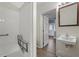 Bathroom featuring accessible shower with seat and modern sink at 133 John Winstead Rd, Louisburg, NC 27549