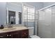 Bright bathroom featuring a shower, vanity with drawers, and large mirror providing a functional space at 133 John Winstead Rd, Louisburg, NC 27549