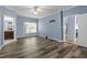 Spacious bedroom with new gray hardwood floors, ceiling fan and access to the bathroom and living room at 133 John Winstead Rd, Louisburg, NC 27549