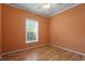 Bedroom with hardwood floors, ceiling fan, and natural light from the window creates a cozy atmosphere at 133 John Winstead Rd, Louisburg, NC 27549