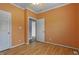Bedroom with hardwood floors, ceiling fan, and natural light from the window and access to other rooms at 133 John Winstead Rd, Louisburg, NC 27549