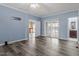 Spacious bedroom with new gray hardwood floors, ceiling fan and access to the bathroom and living room at 133 John Winstead Rd, Louisburg, NC 27549