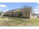 Ranch home with brown siding, front porch, and landscaped yard at 133 John Winstead Rd, Louisburg, NC 27549