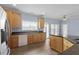 Bright, functional kitchen with wood cabinets, granite counters, and modern appliances at 133 John Winstead Rd, Louisburg, NC 27549