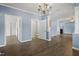 Spacious living room with gray wood-look flooring and open doorways at 133 John Winstead Rd, Louisburg, NC 27549