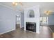 Living room view towards kitchen, featuring hardwood floors and a cozy fireplace at 133 John Winstead Rd, Louisburg, NC 27549
