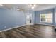 Open living room with gray wood-look floors and blue accent walls at 133 John Winstead Rd, Louisburg, NC 27549