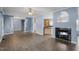 Spacious living room with hardwood floors, fireplace, and open layout to kitchen at 133 John Winstead Rd, Louisburg, NC 27549