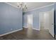 Living room with beautiful chandelier, gray wood floors and light-blue painted walls at 133 John Winstead Rd, Louisburg, NC 27549