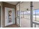Enclosed back porch/sunroom with ceiling fan and view of the water at 133 John Winstead Rd, Louisburg, NC 27549