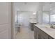 Elegant bathroom featuring dual sinks, marble floors, and a walk-in shower at 137 Alderbranch Cir, Garner, NC 27529