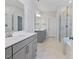Modern bathroom with double vanity, marble floors, and glass-enclosed shower at 137 Alderbranch Cir, Garner, NC 27529