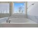 This bathroom features a luxurious tub with chrome fixtures and a view of the outside at 137 Alderbranch Cir, Garner, NC 27529