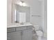 Updated bathroom featuring a large mirror, gray cabinets, and sleek hardware at 137 Alderbranch Cir, Garner, NC 27529