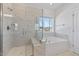 Luxurious bathroom featuring a soaking tub and walk-in glass shower at 137 Alderbranch Cir, Garner, NC 27529
