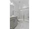 Bathroom featuring marble tile, a glass-enclosed shower, and a gray vanity at 137 Alderbranch Cir, Garner, NC 27529