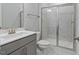 Modern bathroom featuring marble tile, a glass-enclosed shower, and a gray vanity at 137 Alderbranch Cir, Garner, NC 27529