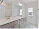 Bathroom with double vanity, gray cabinets, a large mirror, and a toilet at 137 Alderbranch Cir, Garner, NC 27529