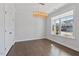 Bright bedroom with hardwood floors, a modern chandelier, and a large window at 137 Alderbranch Cir, Garner, NC 27529