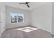 This bedroom offers a comfortable space with carpet floors and a bright window at 137 Alderbranch Cir, Garner, NC 27529