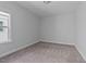 This bedroom offers a cozy space with carpet floors and a bright window at 137 Alderbranch Cir, Garner, NC 27529