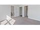Sun-filled bedroom with carpet and three doors leading to a closet and bathroom at 137 Alderbranch Cir, Garner, NC 27529