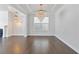 Dining area with hardwood floors, a chandelier, and large windows at 137 Alderbranch Cir, Garner, NC 27529
