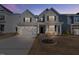 Beautiful gray two-story home with black shutters and a well-maintained front yard, enhancing curb appeal at 137 Alderbranch Cir, Garner, NC 27529