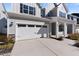Attached two-car garage with white doors and black accents, complementing the home's exterior at 137 Alderbranch Cir, Garner, NC 27529