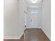 Bright hallway with hardwood floors, white trim, and a view of the front door at 137 Alderbranch Cir, Garner, NC 27529