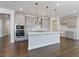 Kitchen with stainless steel appliances, gray cabinets, kitchen island, and stylish backsplash at 137 Alderbranch Cir, Garner, NC 27529