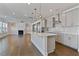 Open concept kitchen with island, stainless steel appliances, and modern backsplash at 137 Alderbranch Cir, Garner, NC 27529